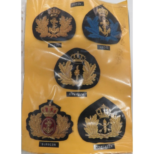 Selection of Foreign Navy Officer Cap Badges
gilt embroidery examples of various ages include Dutch ... Dutch WRNS ... Dutch Surgeon ... Russian ... Polish ... Greek ... Iraq ... Irish ... Italian.  25 items.