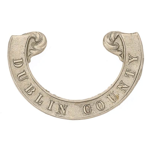 Irish Dublin County Militia Victorian scroll pattern forage cap badge circa 1858-74.  Good scarce die-stamped white metal universal cursive scroll with floreated finials bearing the raised legend DUBLIN COUNTY.  Lead soldered replacement loops, one absent. GC        Gordon Cummings Collection.