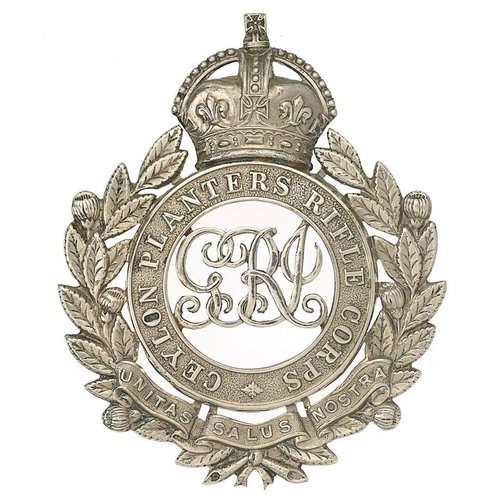 Ceylon Planters Rifle Corps George V Officer pouch belt plate plate circa 1910-36.  Fine scarce die-stamped silvered crowned title circlet within tea sprays bearing UNITA SALUS NOSTRA scroll; GRI cypher to voided centre. Three screw posts. VGC        Bob Betts Collection