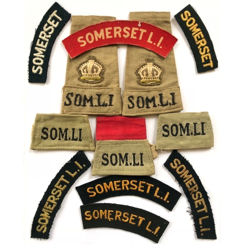 152 - 12 various Somerset Light Infantry Cloth Shoulder Titles.  Including Major KD slip on rank slides   ... 
