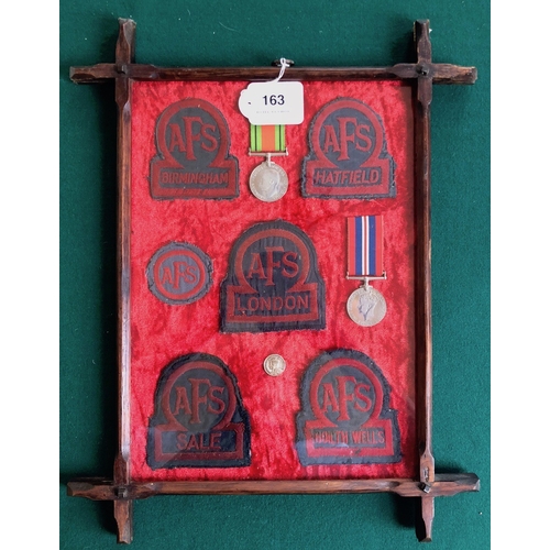 163 - Glass frame of 5 WW2 Auxiliary Fire Service Town Cloth AFS Breast Badges.  Five examples representin... 