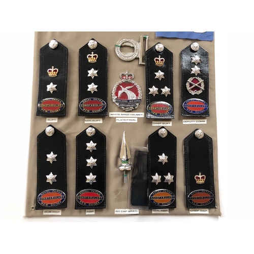 167 - Royal Papua and New Guinea Constabulary 20 items of police insignia.  Board with good display of met... 