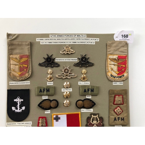 168 - Malta Armed Forces 29 items of insignia.  Board with good display of metal and cloth badges. Most co... 