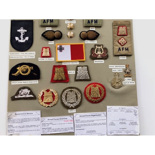 168 - Malta Armed Forces 29 items of insignia.  Board with good display of metal and cloth badges. Most co... 