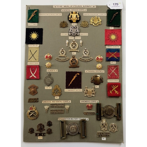 170 - Malaysian Army 49 items of insignia.  Board with good display of metal and cloth badges including tw... 