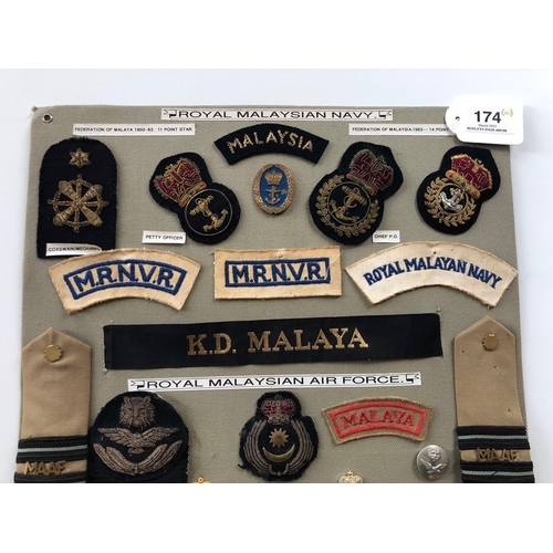 174 - Royal Malaysian Army, Navy and Air Force 40 items of insignia.  Board with good display of metal and... 