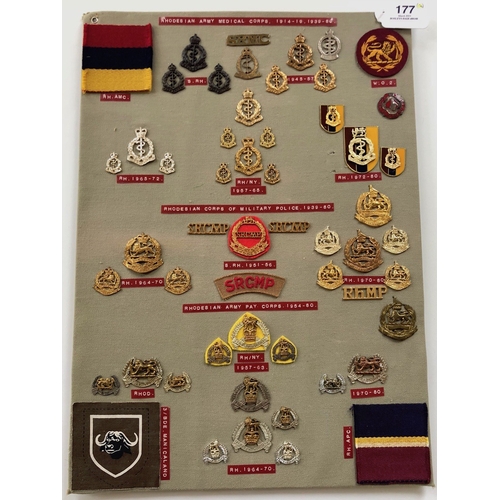 177 - Rhodesian Medical Corps, Military Police, Pay Corps 54 items of insignia.  Board with good display o... 