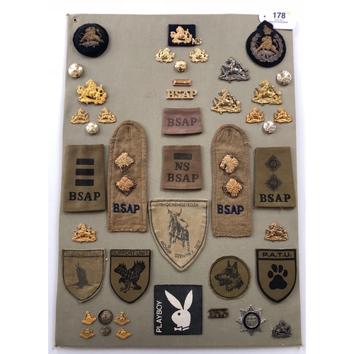 178 - British South African Police 44 items of insignia.  Board with good display of metal and cloth badge... 