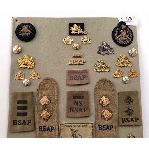 178 - British South African Police 44 items of insignia.  Board with good display of metal and cloth badge... 