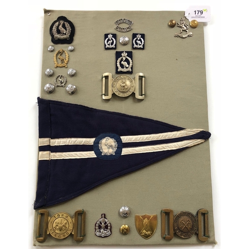 179 - Uganda Police 25 items of insignia.  Board with good display of metal and cloth badges  and buttons ... 