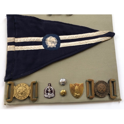 179 - Uganda Police 25 items of insignia.  Board with good display of metal and cloth badges  and buttons ... 
