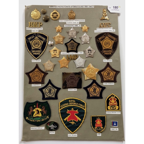 180 - Basutoland, Lesotho Police 34 items of insignia.  Board with good display of metal and cloth badges ... 