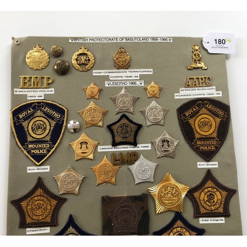 180 - Basutoland, Lesotho Police 34 items of insignia.  Board with good display of metal and cloth badges ... 