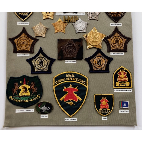 180 - Basutoland, Lesotho Police 34 items of insignia.  Board with good display of metal and cloth badges ... 