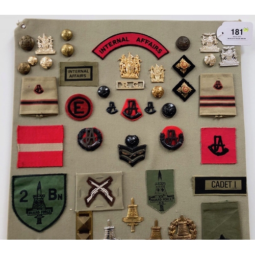 181 - Rhodesian Internal Affairs and Guard Force 50 items of insignia.  Board with good display of metal a... 