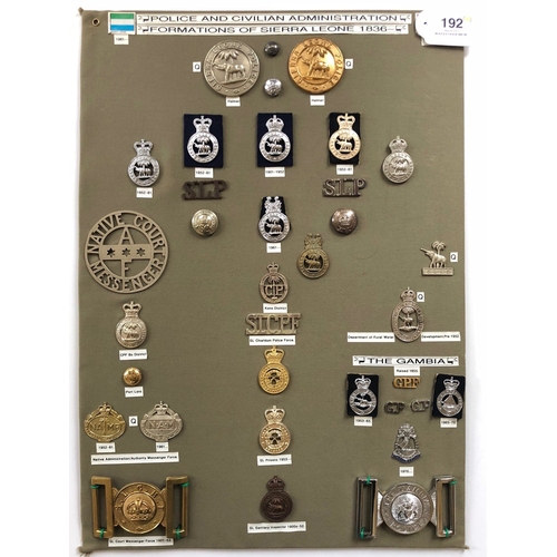 Sierra Leone Police etc. 35 items of insignia.  Board with good display of metal and cloth badges and buttons including two waist belt clasps. Most complete with fixings.        Bob Betts Collection