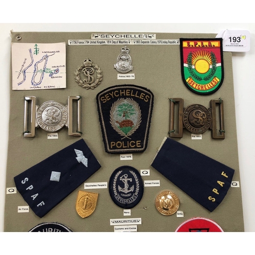 193 - Seychelles Police etc. 17 items of insignia.  Board with good display of metal and cloth badges. Mos... 