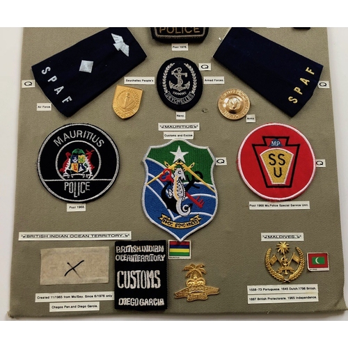 193 - Seychelles Police etc. 17 items of insignia.  Board with good display of metal and cloth badges. Mos... 