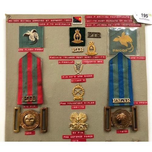 195 - Papua New Guinea 19 items of insignia.  Board with good display of metal and cloth badges including ... 