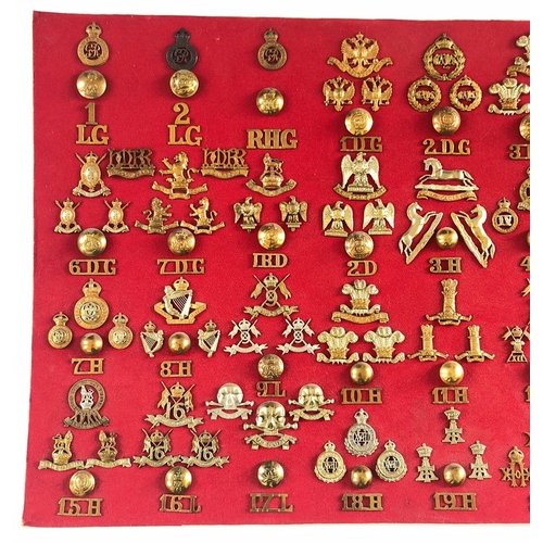 197 - British Army Cavalry Regiments c1914, 159 items.  Board with good display cap badges, collar badges,... 