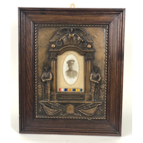 251 - WW1 Hampshire Regiment Memorial Frame. The embossed bronzed effect plaster memorial shows to the cen... 