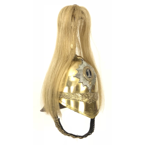 1st (or Kings) Dragoon Guards 1871 pattern helmet. Good scarce example, brass skull decorated with brass laurel leaves; to the front a helmet plate of silvered backing star with gilt strap and silvered 1 to the centre. Brass spike supports a white plume (later Life Guards pattern). To each side are replacement rose head bosses which support a brass leather-backed chin chain. Lining to the interior absent, skull with some dents. Ideal for restoration.