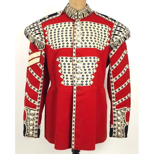 307 - Welsh Guards 1963 dated Drummers tunic.  Scarlet woollen cloth with dark blue facings to the cuff an... 