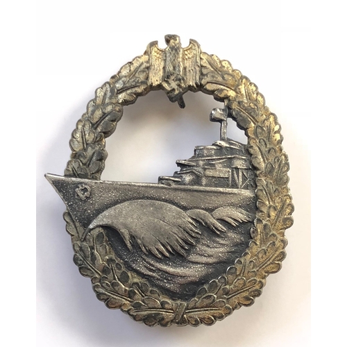 German Third Reich WW2 Kriegsmarine Destroyers War badge by Schwerin.  A good die-cast example. Within a gilt oval oakleaf wreath surmounted by eagle and swastika, a silver speeding destroyer with its bows breaking through the wreath.  Reverse bears Schwerin, Berlin 68 and retains hinged horizontal tapered pin with securing hook also small hook to reverse of eagle.  Some service wear and slight bubbling to plating. GC        Authorised 4th June 1940 by Grand Admiral Raeder.