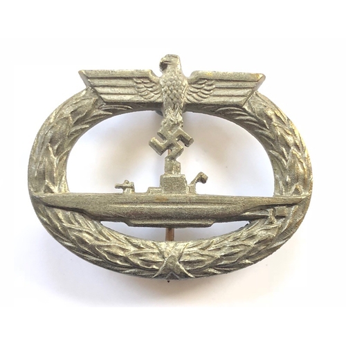 German Third Reich WW2 Kriegsmarine U-Boat Submarine War badge by Gerbruder Wegerhoff, Ludenscheid.  Good late war die-cast gilt example. U-Boat within an oval laurel wreath surmounted by eagle and swastika. Hinged vertical round pin and securing hook reverse which bears circular GWL maker logo. Service wear. GC        Instituted 13th October 1940 by Grand Admiral Raeder.