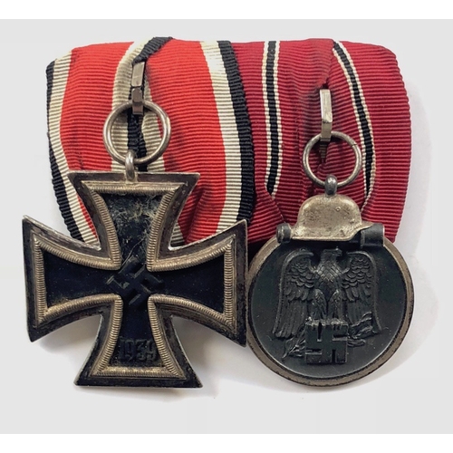 German Third Reich Iron Cross and Eastern Front pair of medals.  Good 1939 Iron Cross 2nd Class with silvered rim and magnetic iron centre together Eastern Front Medal. Mounted Germanic style with mouse grey backing (mothed) and pin fitting. GC