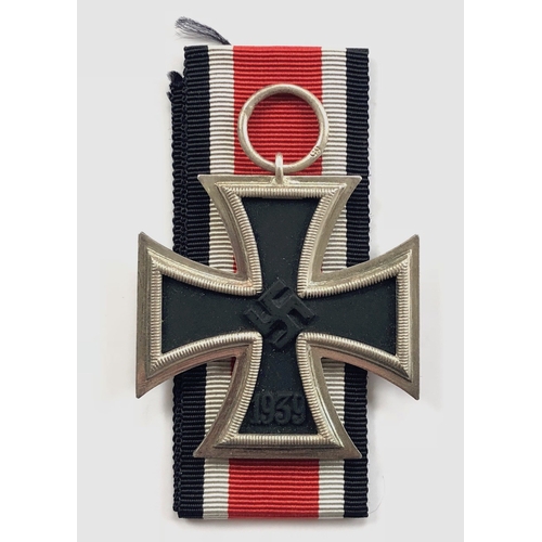 German Third Reich 1939 Iron Cross 2nd Class by Klein & Quenzer, Idar/Oberstein.  A fine example with silvered frame and magnetic iron core, the suspension ring stamped 65. Accompanied by 28 cm length of folded ribbon. VGC