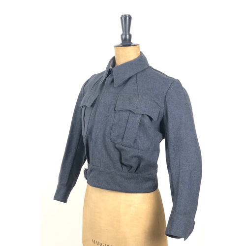 WW2 1943 RAF Womens Auxiliary Air Force WAAF Battledress Blouse Tunic Uniform.  This example retains the 1943 size 4 issue label. Evidence of shoulder eagles having been worn. Clean condition few small moth holes to back.