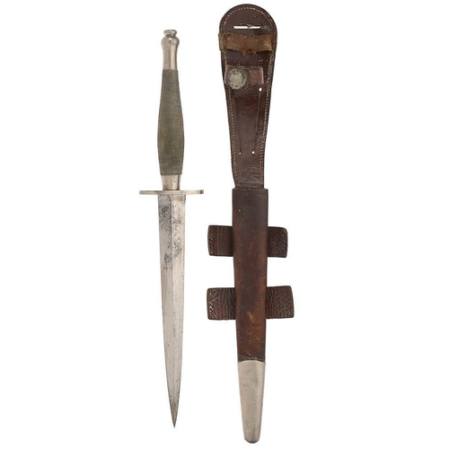 WW2 2nd pattern Fairbairn-Sykes Commando fighting knife. WD 60  A good and scarce example. The hilt with nickel grip of chequered design and stamped to the base with part WD arrow and 60.  Double edged plain spear point blade and fitted with an oval cross guard.  Housed in a brown leather scabbard with nickel rounded chape and with leather and nickel stud retaining strap plus an additional elasticated strap. Complete with four tangs.  The overall condition is good clean bright, with minor age wear.  Blade length 17.9 cm