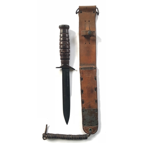 American M3 Combat Trench Knife by Camillus with M6 1943 Scabbard. Scarce example, the 17cm, single edged blade with back edge sharpened point and with details US M3 Camillus. Grey steel crossguard and oval pommel, this with flaming grenade stamp. Leather washer ribbed grip. Housed in its leather M6 pattern scabbard. The lower end with protective steel plates and blind tooled with the details US M6 SBL CO 1943.  GC