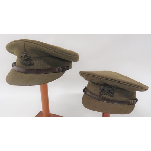 178 - Two British Officer Service Dress Caps
khaki crown, body and stiff peak.  Brown leather chinstr... 