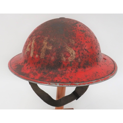 WW2 AFS MKII Steel Helmet
red painted crown and brim.  The front with white stencilled "AFS".  Black treated linen liner.  The frame dated 1938.  1st pattern, oval, rubber crown pad.  Sprung webbing chinstrap.  Some rusting.  