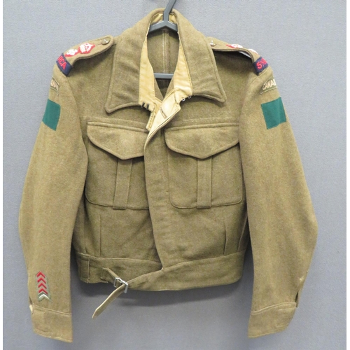 1937 Pattern Battledress With Canadian Badges
khaki woollen, single breasted, closed collar, short jacket.  Pleated chest pockets with buttoned flaps.  Lower extended belt.  Both arms with printed Canada titles over green rectangles.  Both shoulder straps with embroidery Lieutenant Colonel rank over 5 A/T RCA titles.  Lower right cuff with Overseas Service chevrons.  Internal issue label "Battledress Blouses 1940 Pattern" dated 1942.  Clean condition.  
