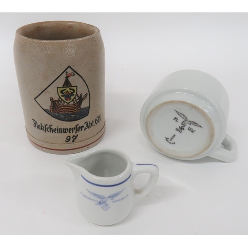 3 Items Of German China
consisting Luftwaffe mess china cup dated 1941 ... Small china jug with transfer "Flughafen-Waggum" ... Pottery tankard with painted shield over "Flakfcheinwerfer ABT 618".  3 items.