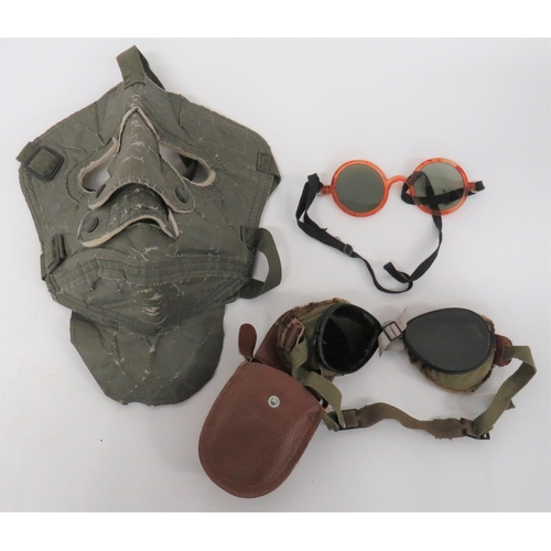 USAAF Cold Weather Face Mask
green treated linen face mask with fold down neck flap.  Green webbing head harness.  Faint issue stamps. Together with a pair of USAF sunglasses with composite frame and elastic head strap ... Pair of American goggles.  Tear shape tinted lenses.  Complete in transit case.  3 items.