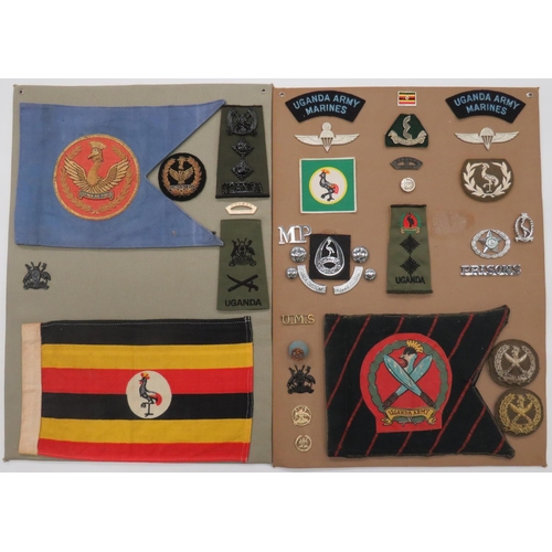 97 - Uganda - 31 Items Of Insignia
Two display boards with good tabulated display of metal and cloth badg... 