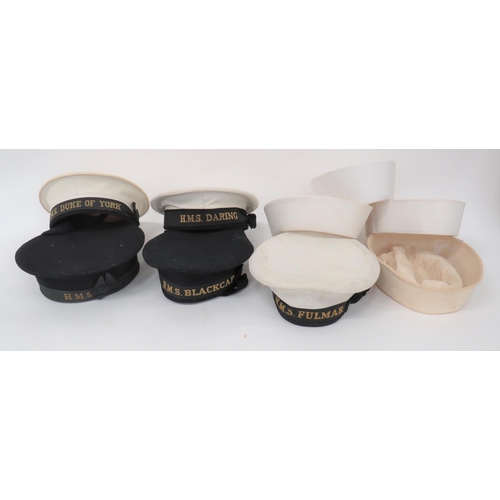 Nine Various Naval Sailors' Hats
consisting 2 x dark blue RN examples with cap tallies HMS Blackcap and HMS ... White blancoed top RN example with HMS Fulmar tally .... 2 x white plastic top RN examples with tallies HMS Daring and HMS Duke Of York ... 4 x US Navy white cotton sailors' hats.  9 items.