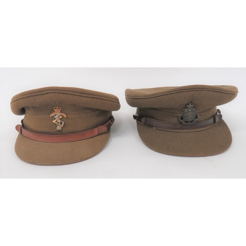 221 - Two Officer Service Dress Caps
consisting khaki crown, body and stiffened peak.  Leather chinst... 