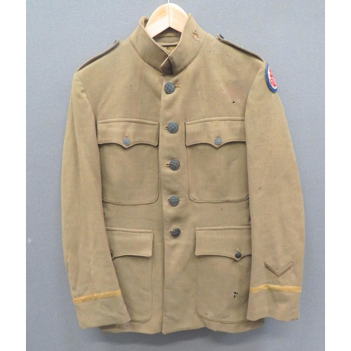 WW1 Period American Officer's Service Dress Tunic
khaki, single breasted, high collar tunic.  Patch chest and lower pockets, all with buttoned flaps.  Left arm with felt Advance Service Of Supply formation badge.  Lower cuff with bullion embroidery chevron.  Blackened American eagle buttons.  Interior pocket with Paris tailor's label.  Some moth damage.  