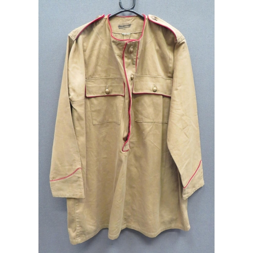 Indian Kurta Pattern Smock Tunic
light khaki drill, round neck smock with part buttoned front. Patch pockets with buttoned flaps.  Red piping to the collar, front and shoulder straps.  Brass KC General List buttons.  Clean condition.  