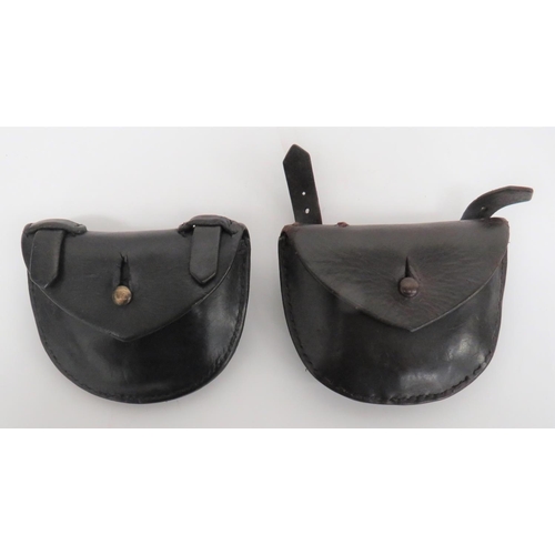 Two 1914 Pattern Revolver Ammo Pouches
small, black leather, half oval pouch.  Top flap secured by a brass stud.  Double belt strap loops fastened by brass buckles.  2 items.