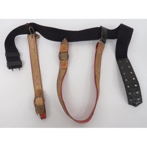 Queens Royal Irish Hussars Officer's Sword Belt And Straps
blue webbing and leather belt with brass buckle.  Scarlet leather, sword hanging straps with shamrock gilt braid facing.  Lower, gilt, double lion mask buckles.  Minor wear. 