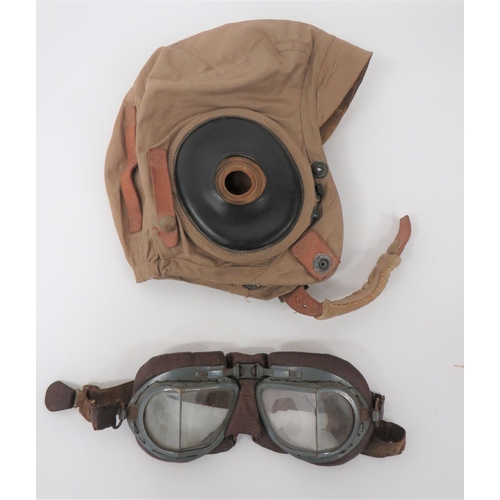 WW2 American AN-H-15 Summer Flying Helmet And MKVIII Goggles
tan cotton, four panel helmet.  Large, black rubber ear pads.  Leather goggle straps.  Leather chinstrap.  Internal chamois ear donuts.  Issue label Size Large.  Together with a pair of post war, MKVIII flying goggles.  Grey painted frame with angled lenses (small crack).  Brown leather face mask with cream leather backing.  Elasticated head strap.  2 items.