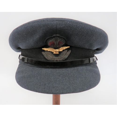 Pre WW2 Royal Air Force Officer's Service Dress Cap
blue grey crown, body and stiffened peak.  Narrow, black patent leather chinstrap secured by black fabric covered buttons.  Black mohair band with bullion embroidery, KC cap badge.  Leather sweatband.  Grey quilted crown lining with "S.W. Silver & Co" tailor's stamp.  