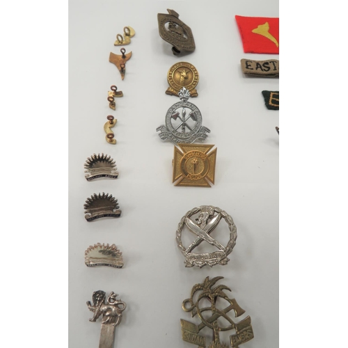 75 - 35 x Various African Badges
including cast brass Sudan Elec & Mech Engrs ... Brass Tanganyika Ve... 