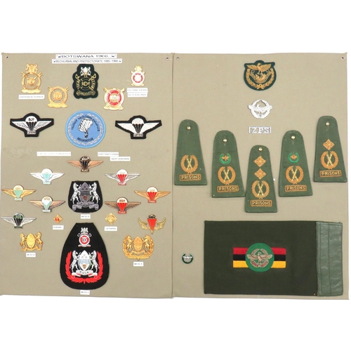 31 x Botswana And Other Badges
two display boards including gilt Defence Force ... Embroidery Para wings ... Chrome and enamel Para wings ... Gilt rank badges ... Various Prison rank badges.  31 items.
Bob Betts' collection. 